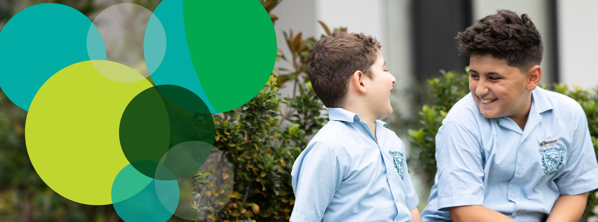 Happy students at St Patrick's Primary Guildford. The students are sitting outdoors.
