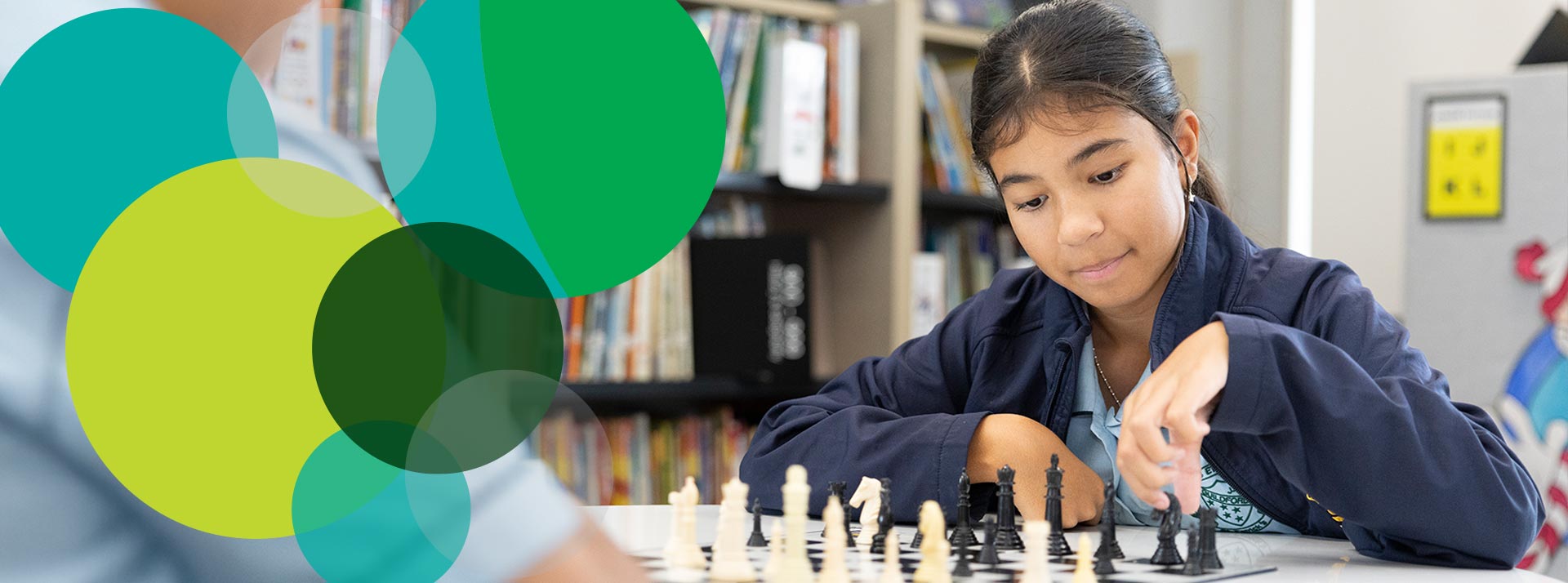 St Pat's Guildford student playing chess in the school library