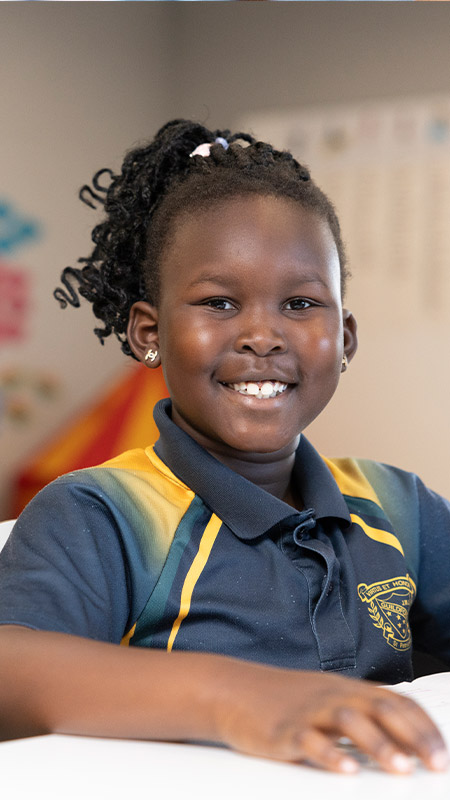 Smiling student in class at St Patrick's Primary Guildford