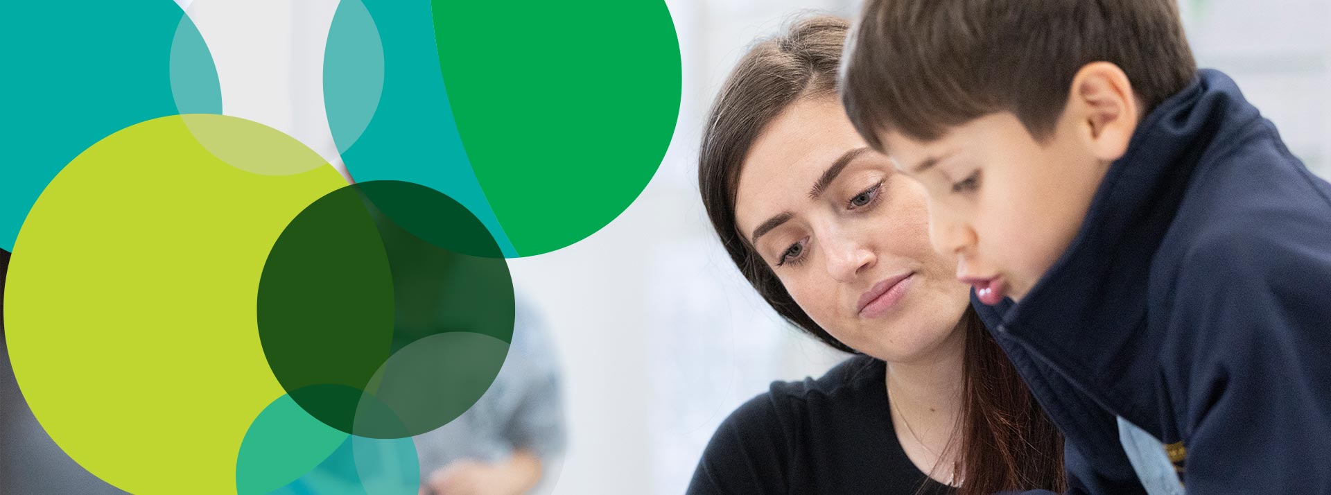 Teacher assisting a St Pat's Guildford student