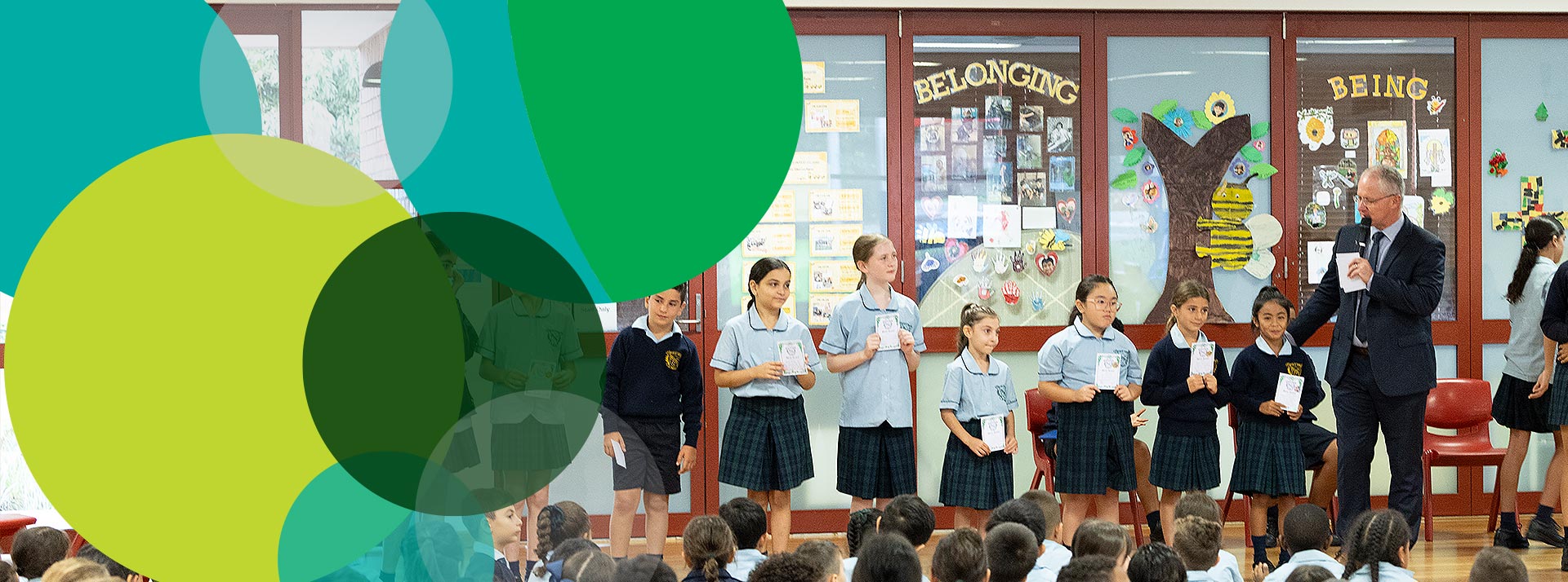 St Patrick's Catholic Primary Guildford School Assembly. Kevin Jones is presenting merit award to students.