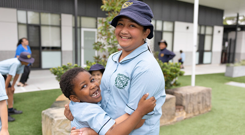 Two students hugging