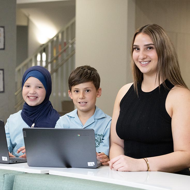 St Patrick's Primary teacher with two students